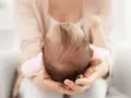 Dolcezza infinita nel tenero abbraccio, mentre la fontanella del neonato si prepara a chiudersi.