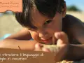 Bambino gioca sulla sabbia, un invito a scoprire come stimolare un bambino a parlare in vacanza.
