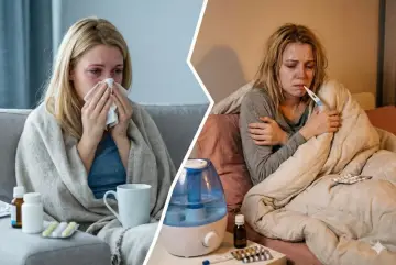 Donna con sintomi influenza 2026: raffreddata, febbricitante e coperta da coperte, con termometro e medicinali.